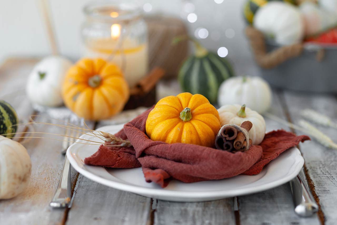 Photo of pumpkins and candle on a wooden table