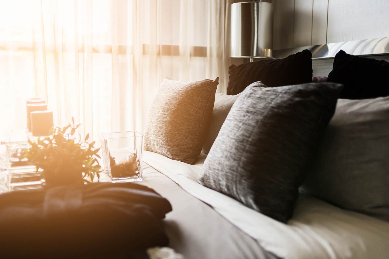 Photo of a bed maid-up with clean white pillows and bed sheets in beauty room