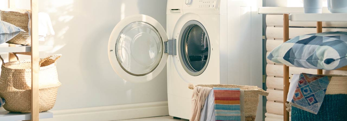 Interior of a real laundry room with a washing machine at home