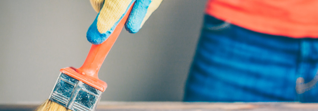 Waxing and oiling with a brush on a wooden table