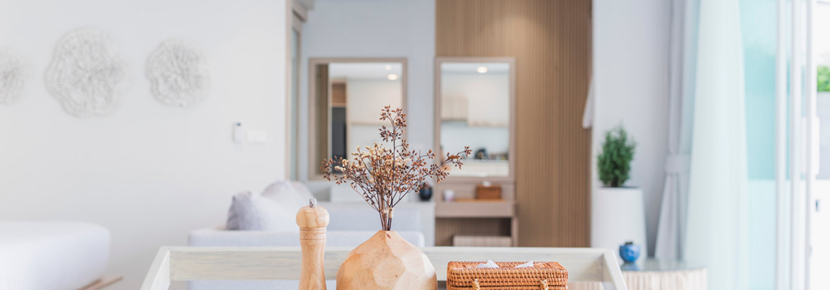 Modern kitchen interior, wooden table, blurred background showing the atmosphere of the room, clean design, home cooking area, neutral colors, natural light stock photo