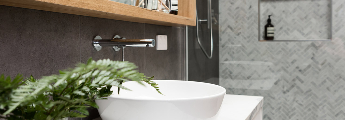Bathroom details clean white basin with shower tiling behind stock photo