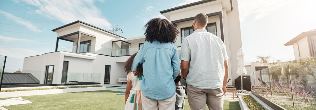 new house and family in their backyard together looking at their property