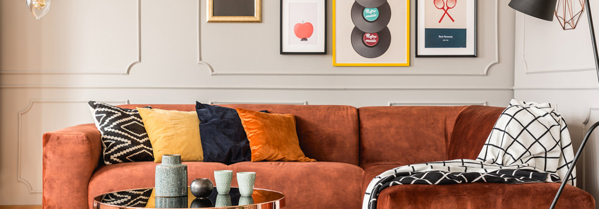 Eclectic living room interior with comfortable velvet corner sofa with pillows stock photo